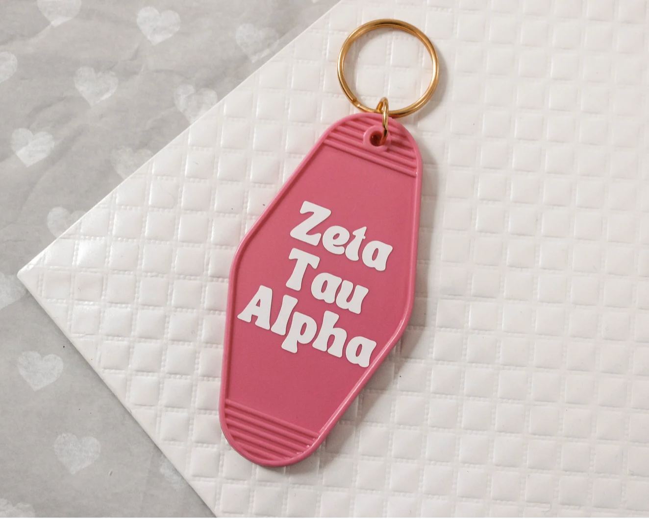 Zeta Tau Alpha Motel Hotel Key Chain in hot pink with white letters and gold ring. ZTA