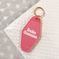 Delta Gamma Motel Hotel Key Chain in Hot pink with white letters and gold ring. DG