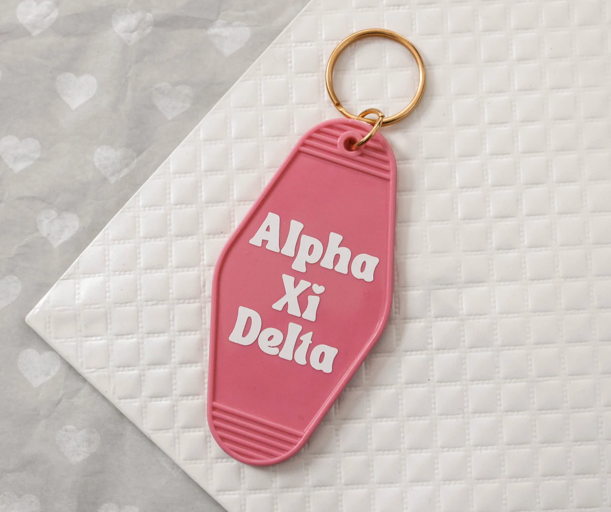 Alpha Xi Delta Motel Hotel Key Chain in Hot pink with white letters and gold ring. AXiD AXD