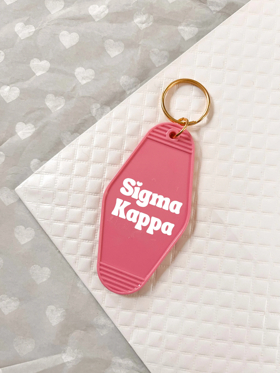 Sigma Kappa Motel Hotel Key Chain in Hot pink with white letters and gold ring. SK