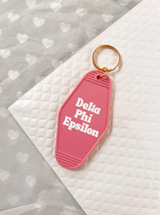 Delta Phi Epsilon Motel Hotel Key Chain in Hot pink with white letters and gold ring. DPhiE