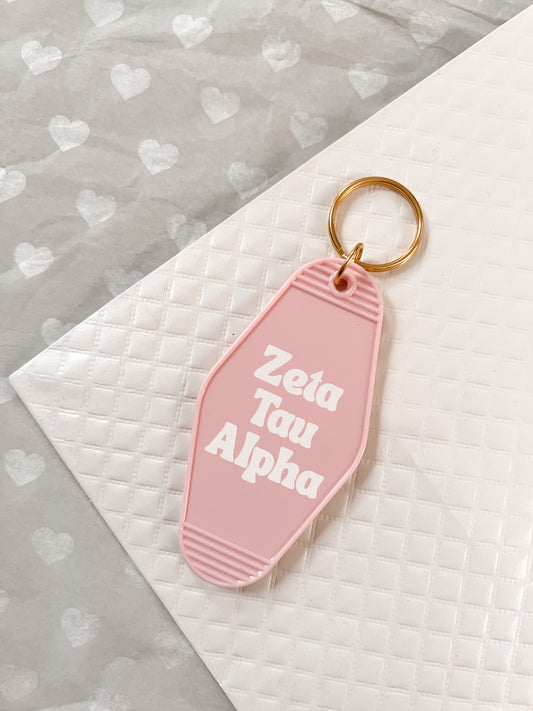 Zeta Tau Alpha Motel Hotel Key Chain in Soft pink with white letters and gold ring. ZTA