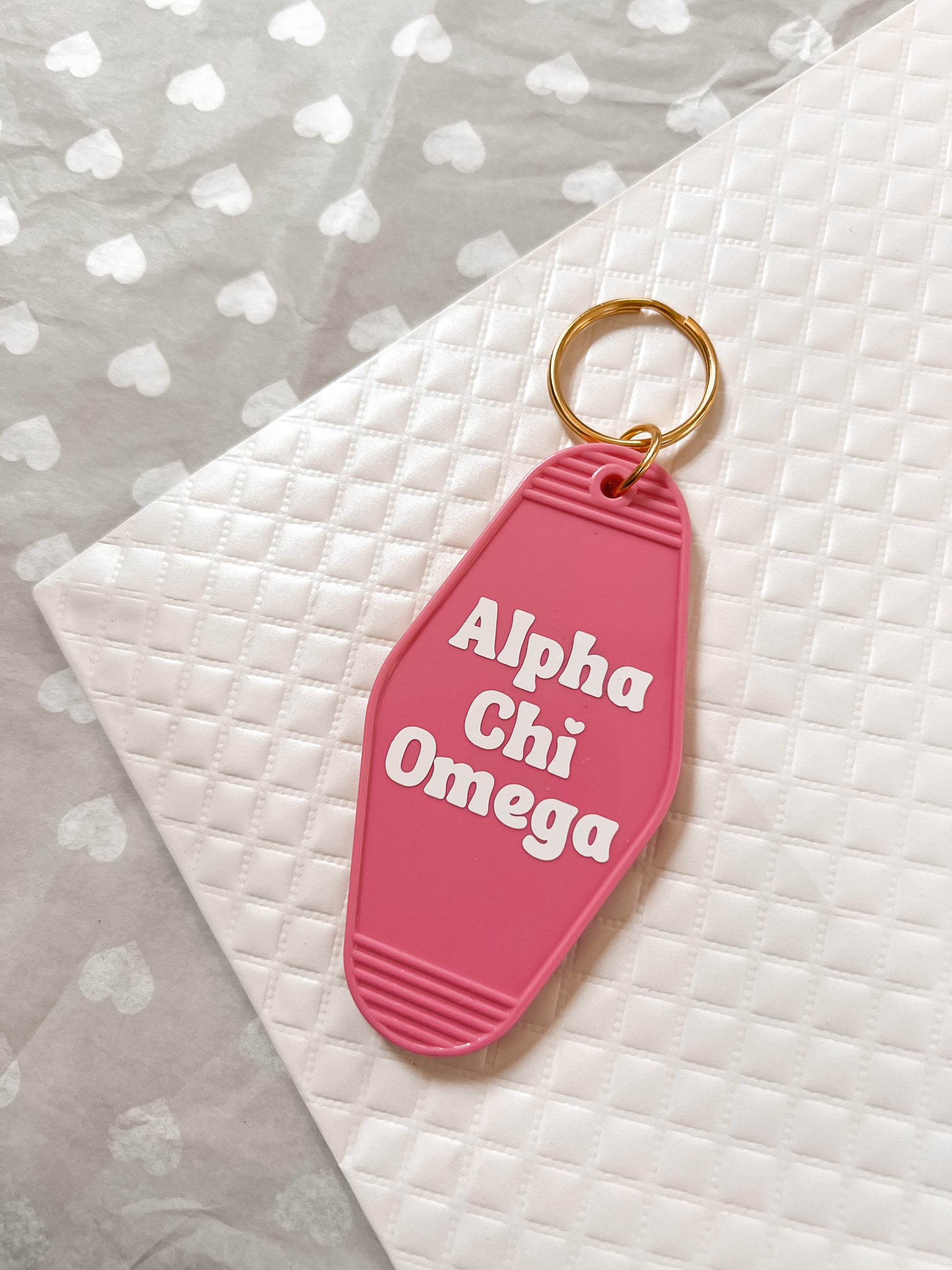 Alpha Chi Omega Motel Hotel Key Chain in Hot pink with white letters and gold ring. AXO