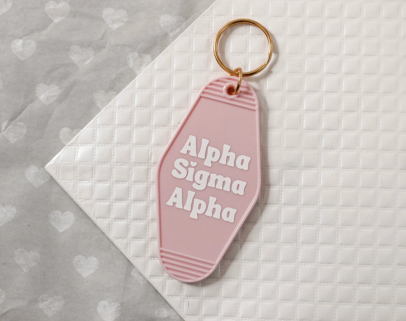 Alpha Sigma Alpha Motel Hotel Key Chain in Soft pink with white letters and gold ring. ASA