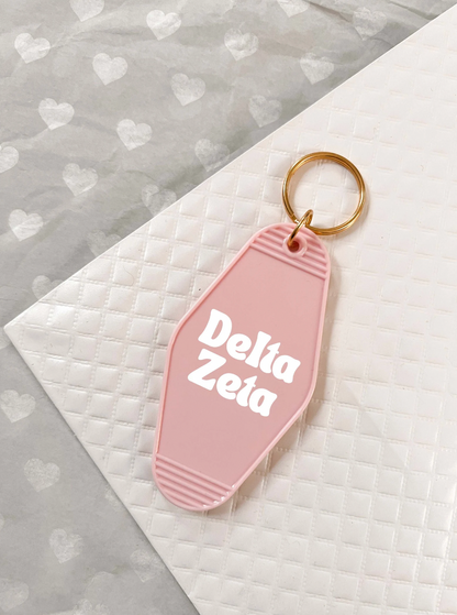 Delta Zeta Motel Hotel Key Chain in Soft pink with white letters and gold ring. DZ