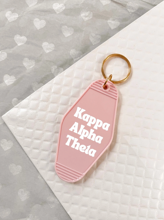 Kappa Alpha Theta Motel Hotel Key Chain in Soft pink with white letters and gold ring. KAT Theta